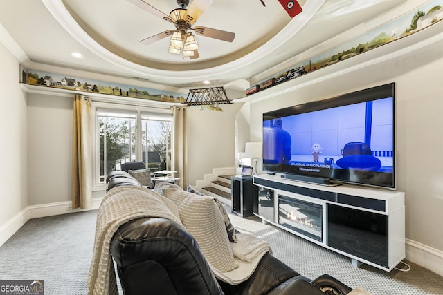 living room featuring ceiling fan, baseboards, carpet flooring, recessed lighting, and a raised ceiling