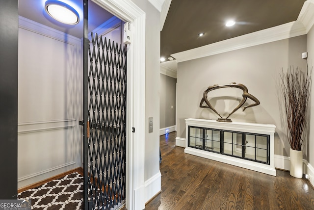 corridor featuring baseboards, ornamental molding, elevator, recessed lighting, and wood finished floors