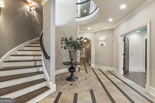 interior space with recessed lighting, baseboards, arched walkways, and ornamental molding