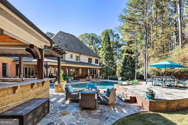 pool featuring a patio and an outdoor fire pit