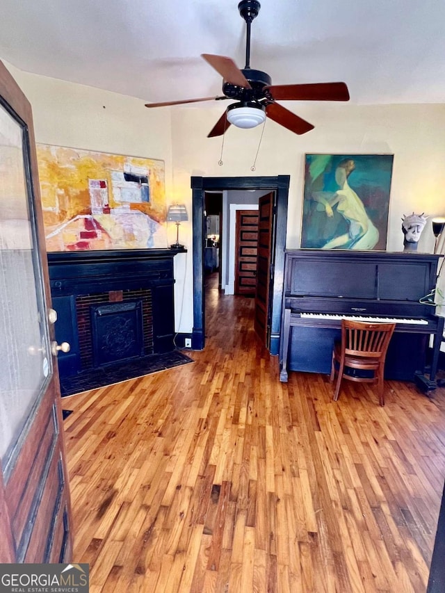 living room with a fireplace with flush hearth and wood finished floors