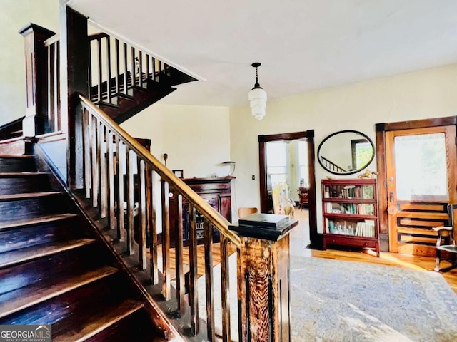 stairs featuring wood finished floors