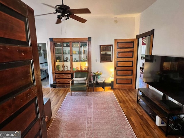 living area featuring ceiling fan and wood finished floors