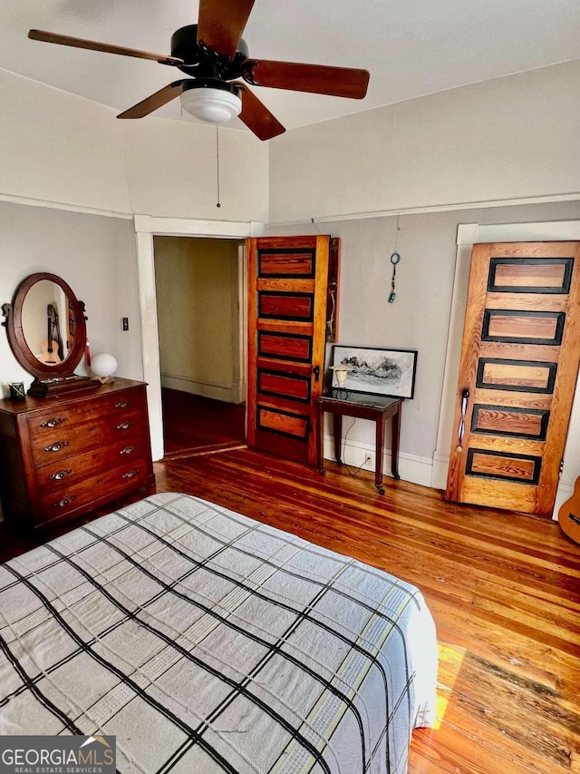 bedroom with a ceiling fan and wood finished floors