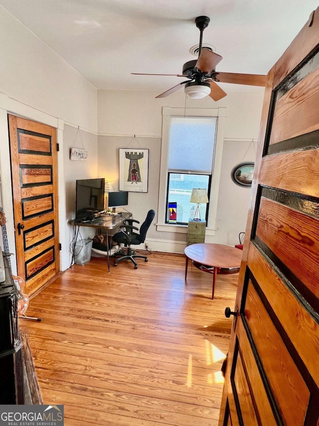 home office with ceiling fan and wood finished floors