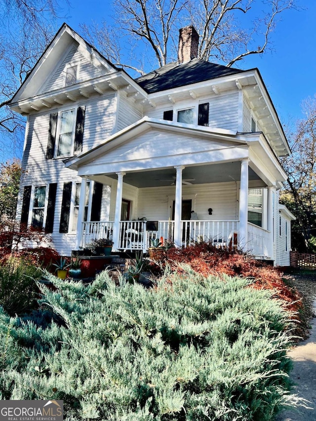 view of front of home featuring a porch and a chimney