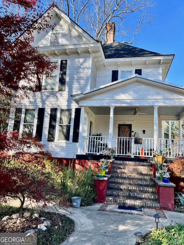 view of front of property featuring a chimney and a porch