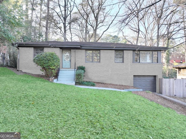 view of front of property featuring a front yard, brick siding, fence, and an attached garage