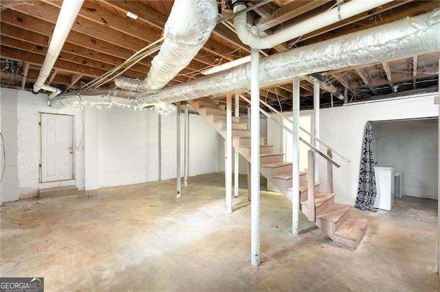 unfinished basement with washer / dryer and stairway