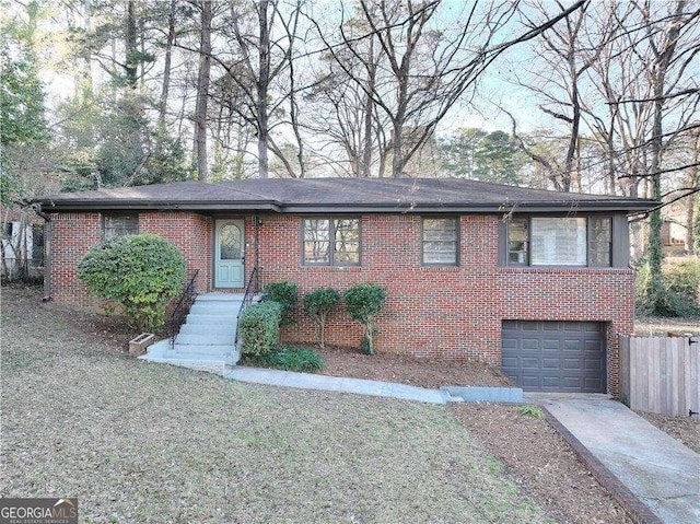 ranch-style house with driveway, a garage, fence, and brick siding