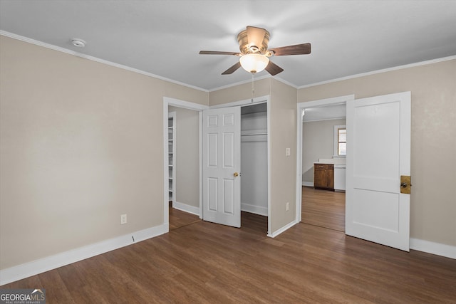 unfurnished bedroom with crown molding, baseboards, and wood finished floors