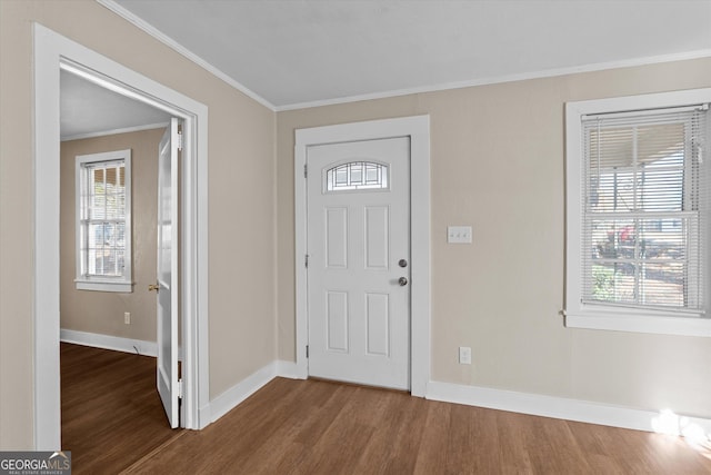 entryway featuring ornamental molding, baseboards, and dark wood-style floors