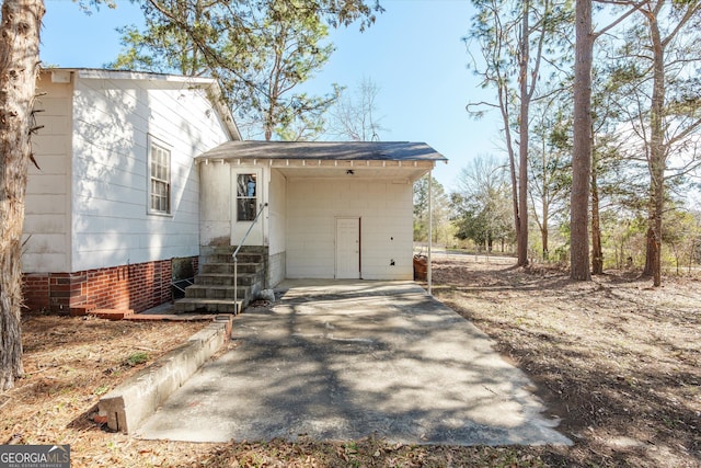 exterior space featuring entry steps and driveway