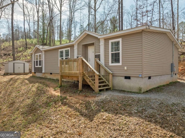 view of front of home with crawl space, an outdoor structure, driveway, and a storage shed