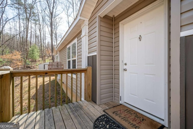 entrance to property with a wooden deck