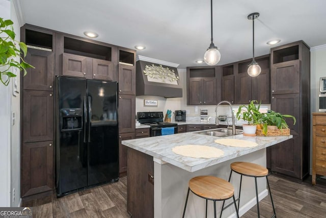 kitchen with open shelves, light countertops, dark brown cabinetry, a sink, and black appliances