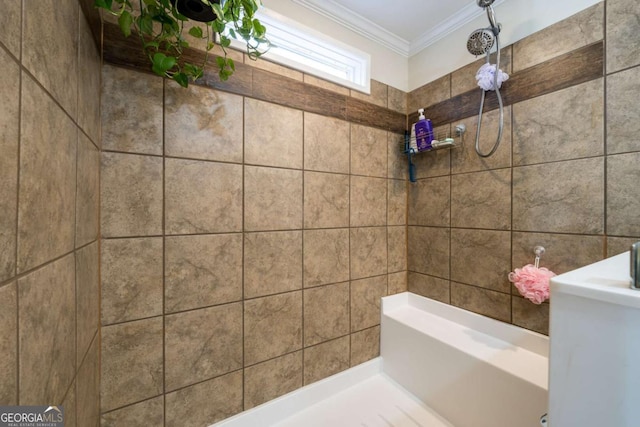 full bath featuring ornamental molding and tiled shower