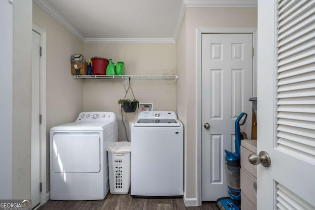 washroom featuring laundry area, washer and clothes dryer, wood finished floors, and crown molding