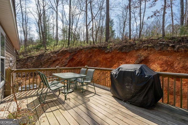 deck featuring a grill and outdoor dining space