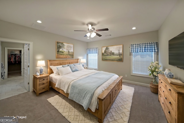 bedroom featuring recessed lighting, light carpet, ceiling fan, and a spacious closet