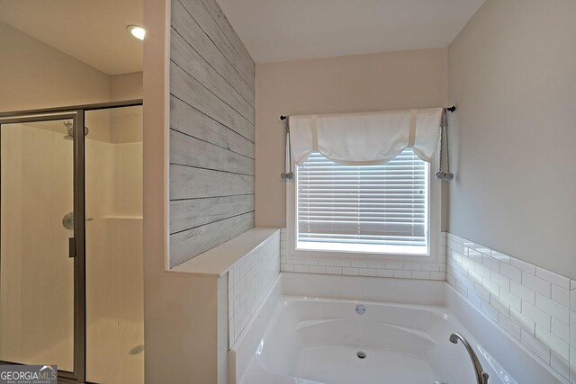 bathroom with a shower stall, double vanity, marble finish floor, and a sink