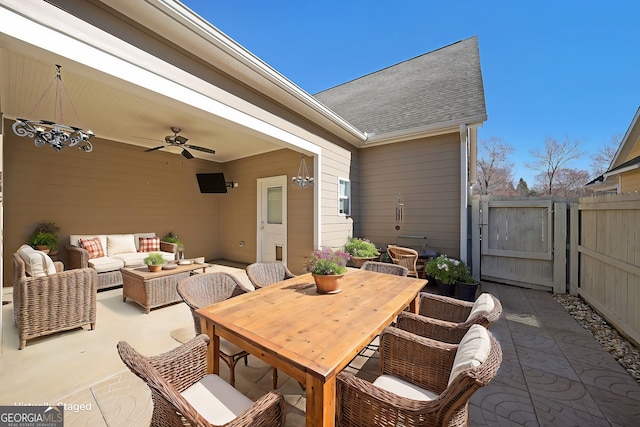 view of patio / terrace featuring a gate, an outdoor living space, fence, outdoor dining area, and ceiling fan