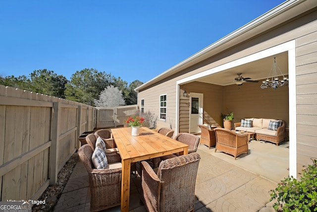 view of patio / terrace with outdoor dining space, outdoor lounge area, a fenced backyard, and a ceiling fan