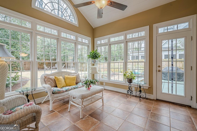 sunroom with ceiling fan and vaulted ceiling