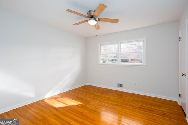 empty room with visible vents, baseboards, and light wood-style floors