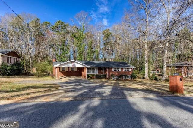 view of front of home with brick siding and driveway