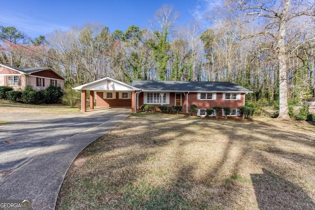 single story home with concrete driveway, a carport, and brick siding