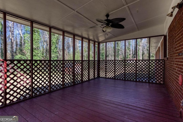 unfurnished sunroom featuring a ceiling fan