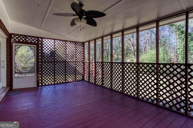 unfurnished sunroom with plenty of natural light and a ceiling fan