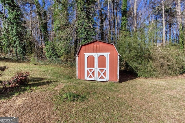 view of shed featuring fence