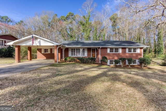 view of front of house with a carport, aphalt driveway, a front yard, and brick siding