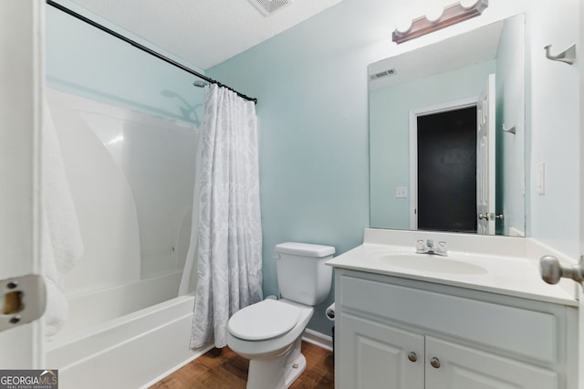 full bathroom featuring shower / tub combo, visible vents, toilet, wood finished floors, and vanity