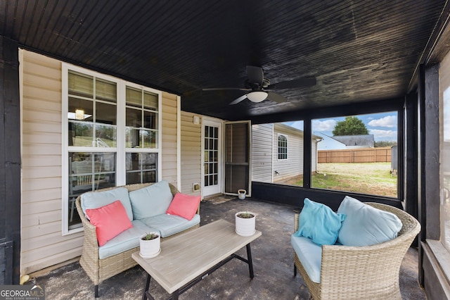 sunroom / solarium featuring ceiling fan