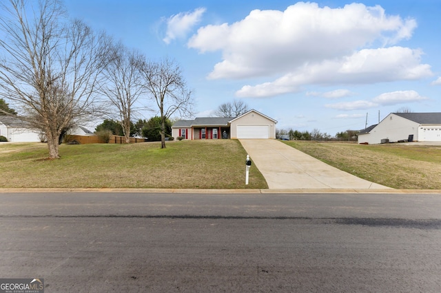 ranch-style home with a garage, a front lawn, and concrete driveway