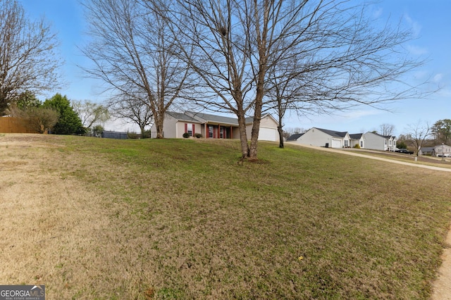 view of yard with a garage and fence