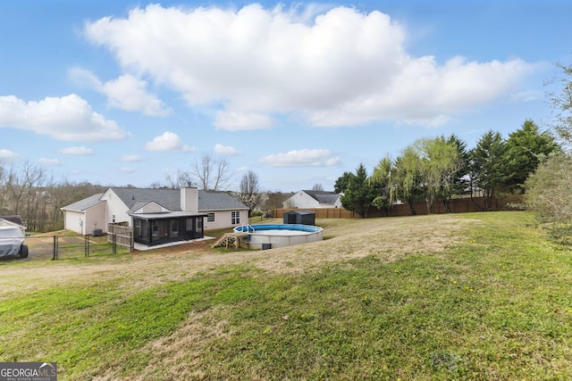 view of yard featuring an outbuilding, a fenced backyard, and a fenced in pool