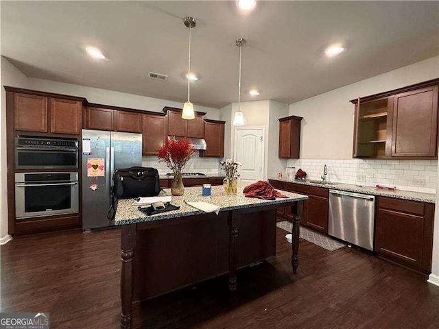 kitchen featuring visible vents, a kitchen bar, appliances with stainless steel finishes, and open shelves