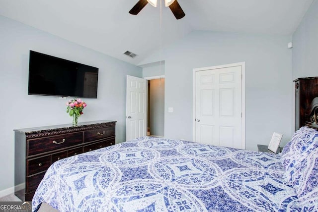 carpeted bedroom with visible vents, a ceiling fan, and vaulted ceiling