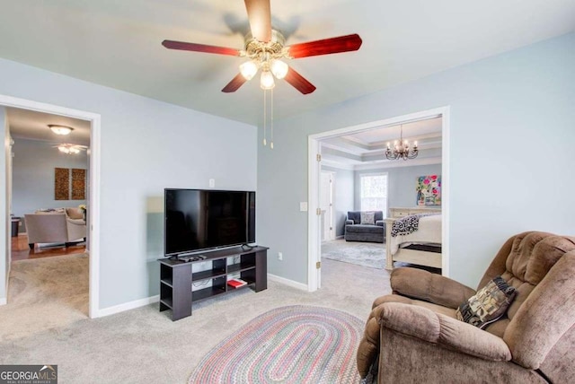 carpeted living room featuring a raised ceiling, baseboards, and ceiling fan