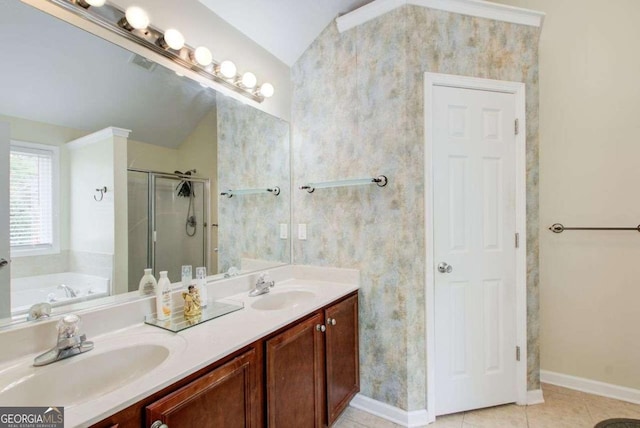 full bath featuring tile patterned flooring, a shower stall, vaulted ceiling, double vanity, and a sink