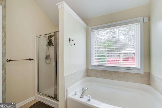 full bathroom featuring a garden tub and a stall shower