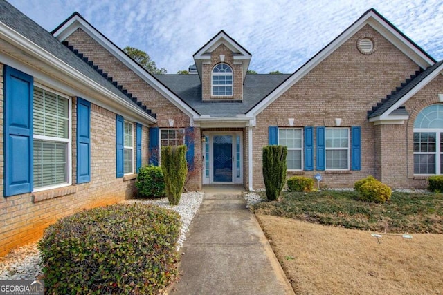 view of exterior entry with brick siding