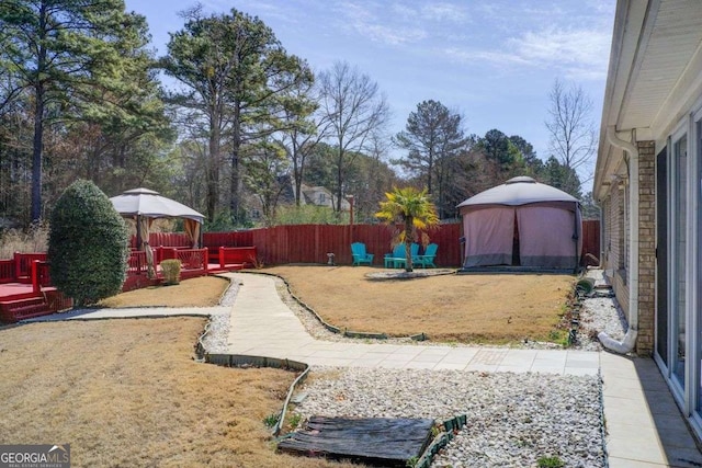 view of yard with a deck and a fenced backyard