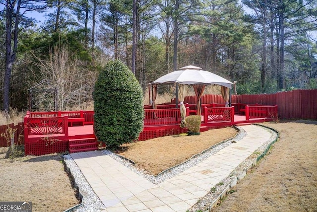 view of yard featuring a deck and fence