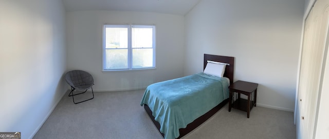 bedroom featuring carpet, lofted ceiling, and baseboards