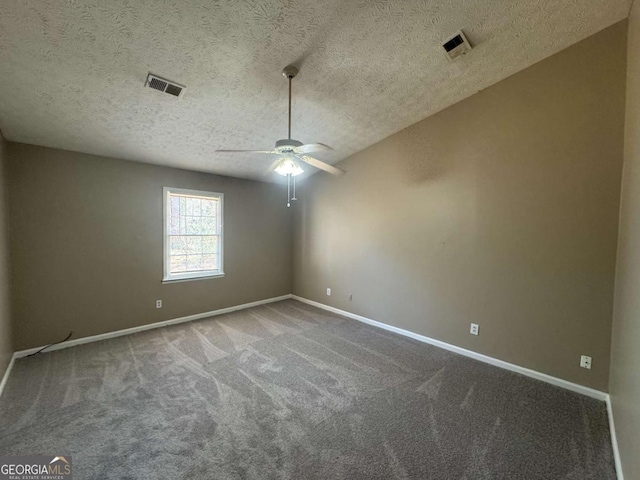 empty room with carpet, baseboards, visible vents, and a ceiling fan